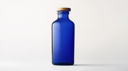 Obraz premium Elegant blue glass bottle with wooden cap isolated on clean white backdrop showcasing minimalist design and versatile usage options