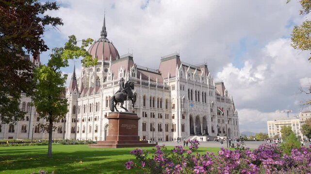 Beautiful Parliament building in Budapest and equestrian statue of Francis II Rakoczi. City park in Parliament Square outside the Parliament Building located on the bank of Danube in Budapest Hungary