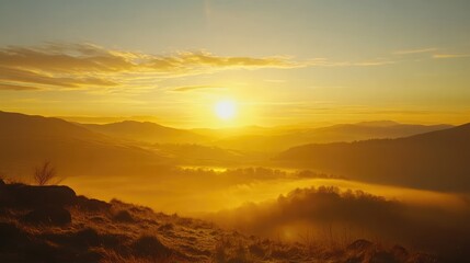 Obraz premium Golden sunrise landscape over Lake District hills from Loughrigg Fell with misty valleys and warm light illuminating the countryside.