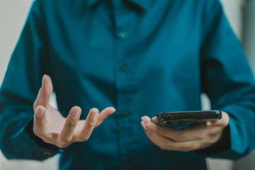 person in blue shirt holds smartphone while gesturing with hands, expressing confusion or frustration. scene captures moment of communication and emotion