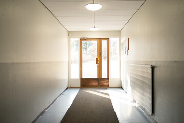 Bright Minimalist Hallway With Wooden Doors and Natural Light Streaming In, Creating a Calm and Inviting Atmosphere in a Modern Interior Space Designed for Simplicity and Elegance