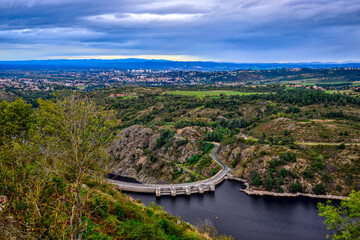 Saint-Victor-sur-Loire, France - October 5th 2024 : View of the River la Loire from a mountain close to Saint-Victor. You can see Grangent dam and the city of Andrézieux-Bouthéon.
