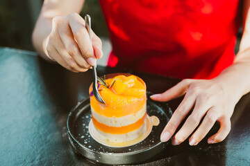 Delicious dessert with layers of orange and cream, served on plate. person enjoys this sweet treat...