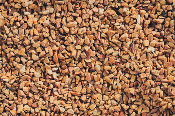 Gravel texture background with small, irregular stones earthy tones. This natural material is often...