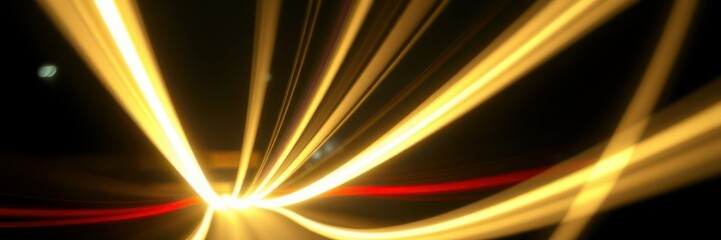 Bright streaks of light create an abstract design during a nighttime drive on a busy urban road