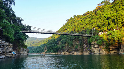 Small cable bridge crossing the Dawki River in Meghalaya, India.