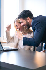 Fototapeta premium Excited Business Team Celebrating Success in Office.Vertical