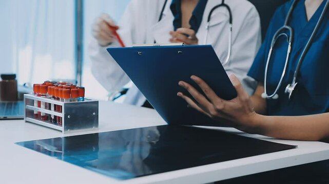 Pharmaceutical sales representative talking with female doctor in medical building. Hospital director consulting with healthcare staff.