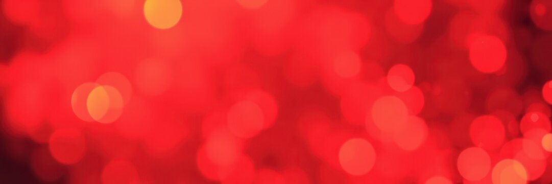 Bright red bokeh lights create a festive atmosphere for celebrations during the evening hours