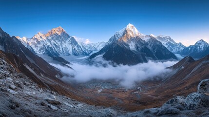 Obraz premium A breathtaking panoramic view of snow-capped mountains and valleys under a clear blue sky.
