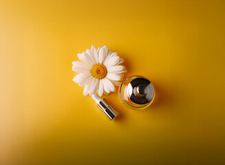 Fototapeta premium A single chamomile flower rests beside a small, amber bottle with a silver cap on a vibrant yellow background. The scene suggests natural beauty products or skincare.