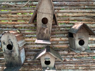 Rustic Charm: Vintage Birdhouses on Wooden Fence