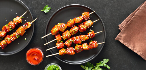 Teriyaki chicken skewers on plate.