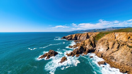 A stunning coastal view featuring rocky cliffs, crashing waves, and a clear blue sky, showcasing the beauty of nature.