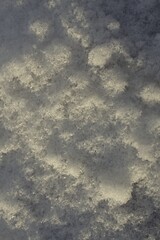 A high-resolution photograph of frozen snow with intricate crystal patterns and natural texture. Ideal for backgrounds, winter designs, and seasonal creative projects.