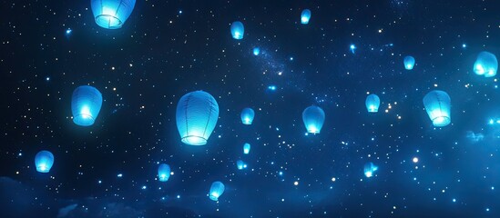 Obraz premium Glowing blue sky lanterns at night.