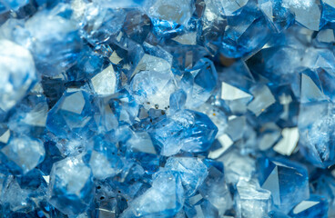 Blue Crystal Mineral Stone. Gems. Mineral crystals in the natural environment. Texture of precious and semiprecious stones. Seamless background with copy space colored shiny surface of precious stones