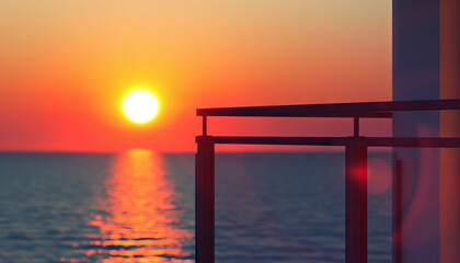 Sitting on a balcony, watching the sun slowly set over the horizon, I marveled at the beauty of the changing colors and felt a deep sense of calmness and gratitude