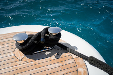 Detail shot of a mooring line tied off on a cleat on the stern area of a modern superyacht docked...