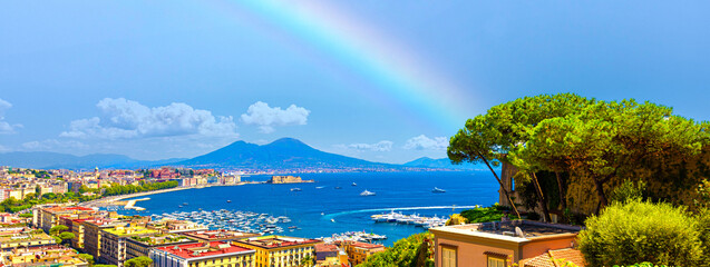 Naples, Italy. Gulf of Naples with rainbow. View from Sant'Antonio a Posillipo of Mount Vesuvius, Mergellina, Castel dell'Ovo. View from above on the city. Banner header image.