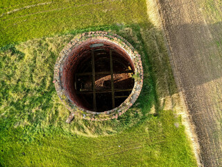 Aerial view of derelict windmill in field