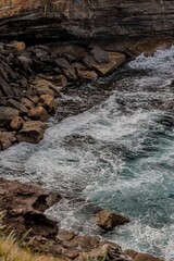 View of rugged coastal cliffs meeting the vast ocean.