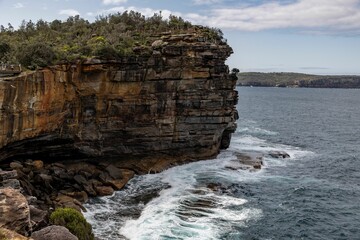 Scenic view of rugged coastal cliffs and ocean waves.