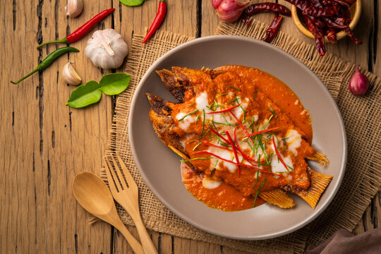 Fried Red Tilapia Fish with red curry sauce,Thai Choo Chee Fish Curry in a plate.Top view