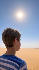 Fototapeta premium A child gazes at the sun over a vast desert landscape.