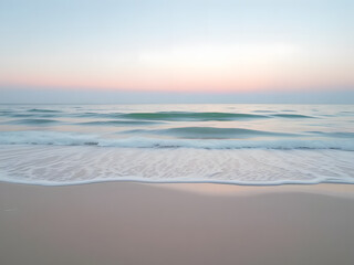 Fototapeta premium Soft waves rippling across a minimalist sandy beach, with pastel sunset tones reflecting on the water 