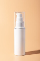 A white cosmetic tube on a pastel peach background. Ideal for mockups, branding presentations, and product marketing
