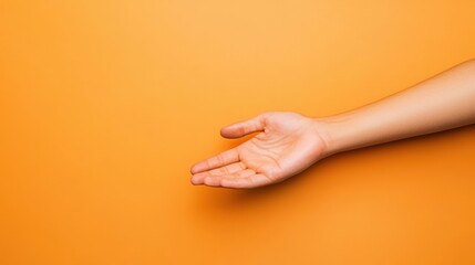 Helping hand reaches out against a vibrant orange background for support