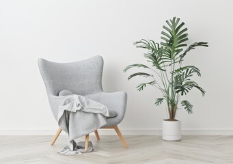 Cozy living room with a comfortable armchair. a throw blanket. and a green plant in a white pot. standing on a herringbone wooden floor against a white wall