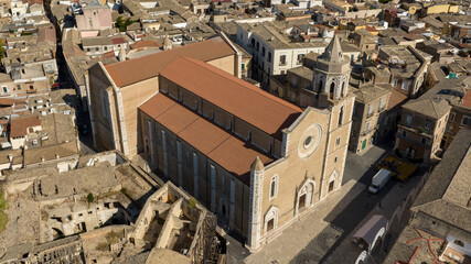 Fototapeta premium Aerial view of the Basilica of Santa Maria Assunta in the historic center of Lucera, in province of Foggia, Puglia, Italy. The cathedral of the town is dedicated to the Assumption of the Virgin Mary.