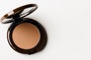 Natural bronzer compact placed on clean surface showcasing warm tones ideal for enhancing skin glow