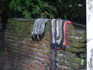 two doormats placed on the brick wall in the photo at night