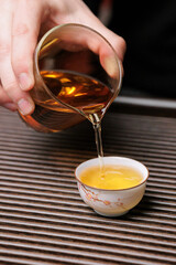 Pouring tea into a traditional cup creates a unique and delightful fusion of flavors and aromas