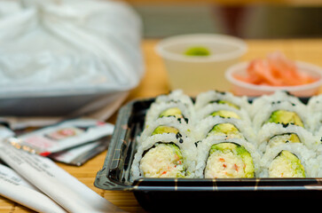 Several sets of sushi to go over blurred background.