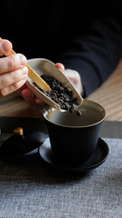 Experience the elegance of tea preparation using your hands along with a beautiful black tea cup