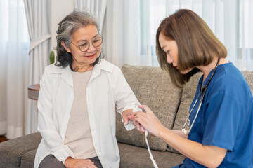 Obraz premium asian senior woman giving a health interview to health personal service in uniform,female nurse measuring pulse oximeter patient,elderly health care,home care