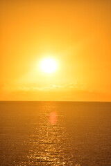 Stunning Pacific Ocean sunset with beams of colourful light shining up from the sea and islands in Fiji