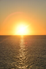 Fototapeta premium Stunning Pacific Ocean sunset with beams of colourful light shining up from the sea and islands in Fiji