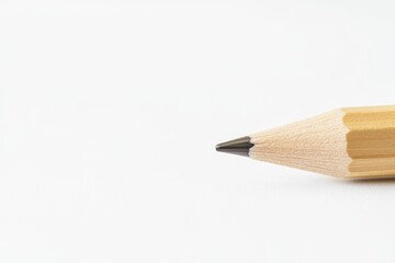 Fototapeta premium CloseUp of a Wooden Pencil Tip Set Against a Clean White Background Surface. Detailed close up view of a finely sharpened pencil. Pristine white backdrop. Pencil point. Business and education concept