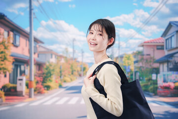 住宅街を歩く若い女性