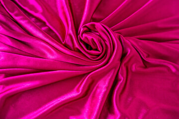texture pink silk fabric. Luxury silky, satiny fabric background with waves and drapery. Background...