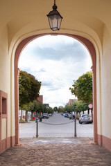 Fototapeta premium arch under town hall at Amalienstrasse 35 in historic city center of Karlsdorf-Neuthard, Now this building local museum, city landmark Germany