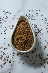 Brown Seeds Placed Elegantly in a Decorative Spoon Surrounded by Spilled Seeds Nearby