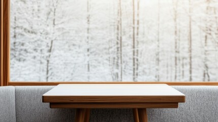 Empty table in warm cafe overlooking snow covered trees in winter sunlight