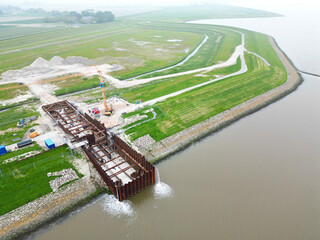 Aerial view of the construction of a tidal inlet. When finished this inlet will replace the current agricultural conditions to a saline aquaculture environment. Bierum, Eemsdelta, The Netherlands