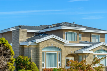 Two story stucco luxury house with nice summer  landscape in Vancouver, Canada, North America. Day time on June 2024.